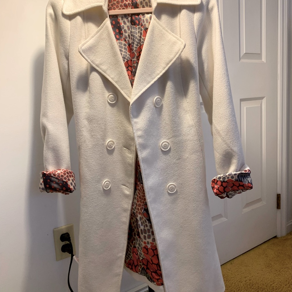 This coat is a Creamy white with beautiful red interior by Buffalo.